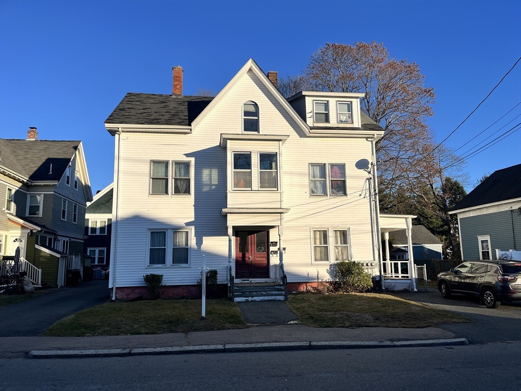 a front view of a residential apartment building with a yard