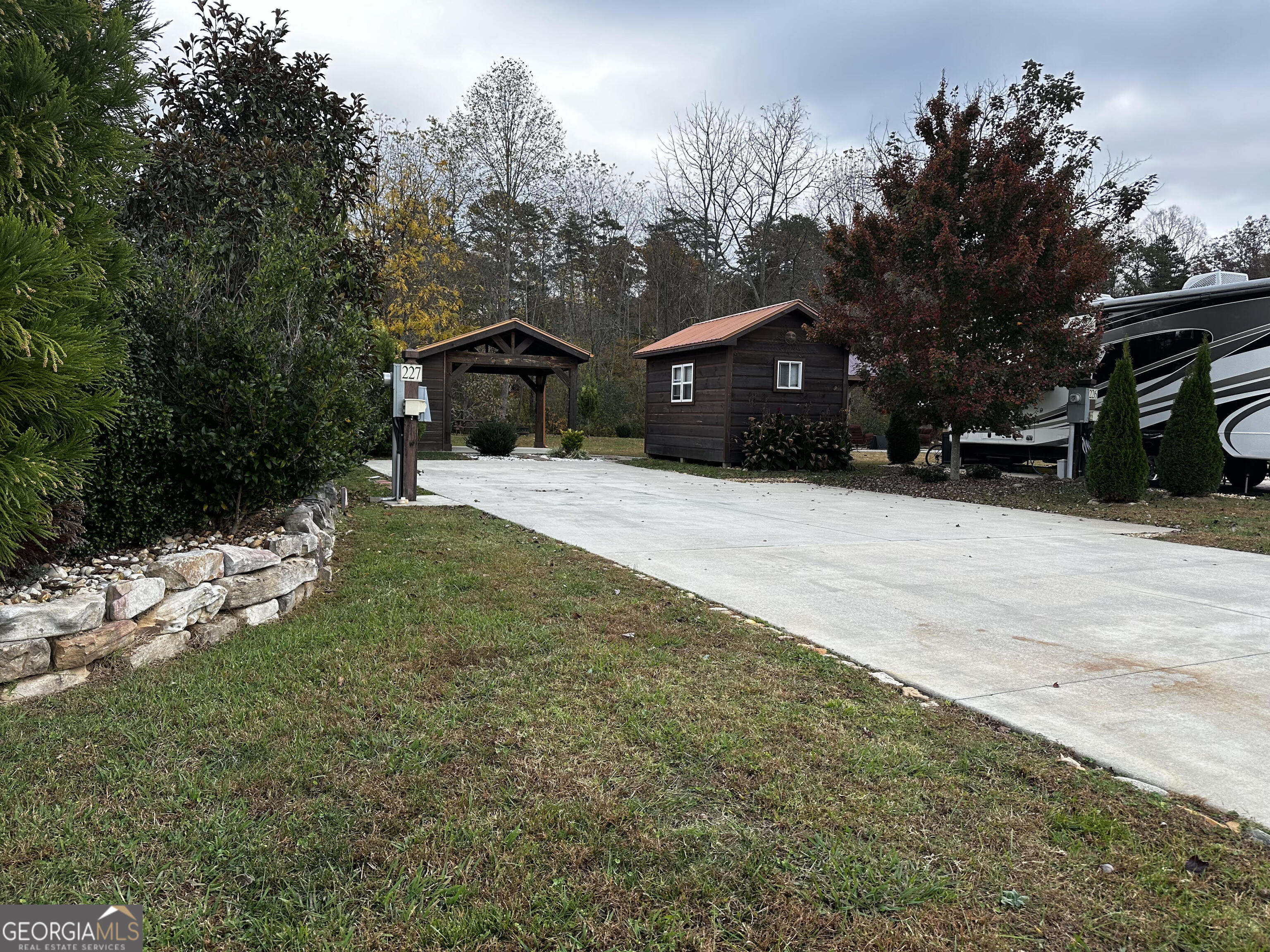 a front view of a house with a yard covered with snow