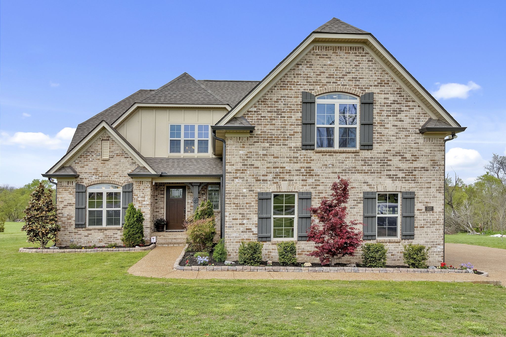 a front view of a house with a yard