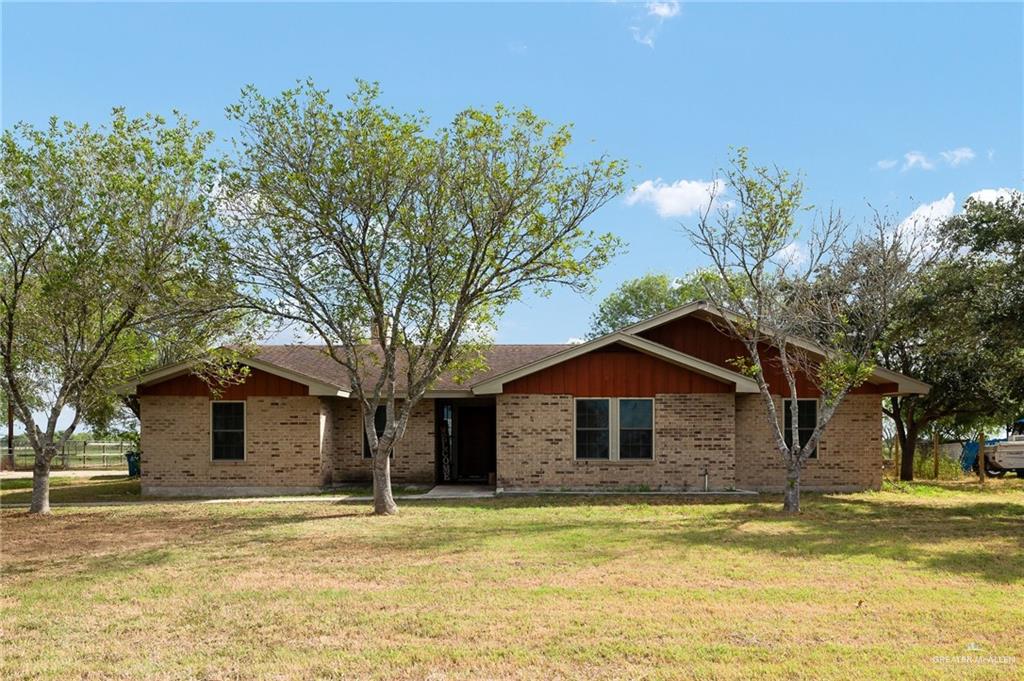 Ranch-style house featuring a front lawn