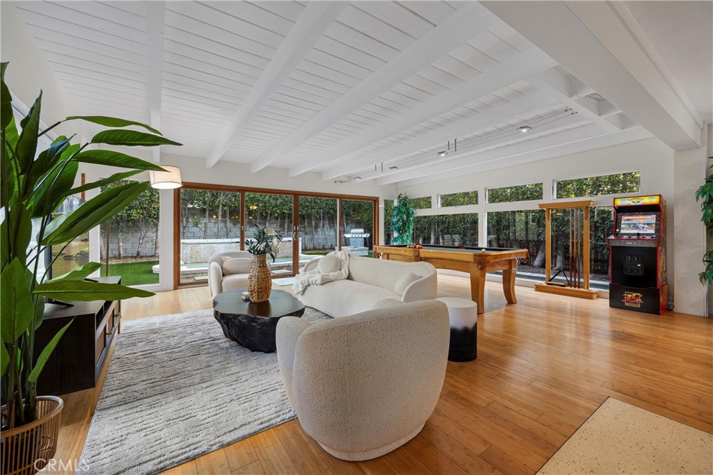 a living room with furniture and a wooden floor