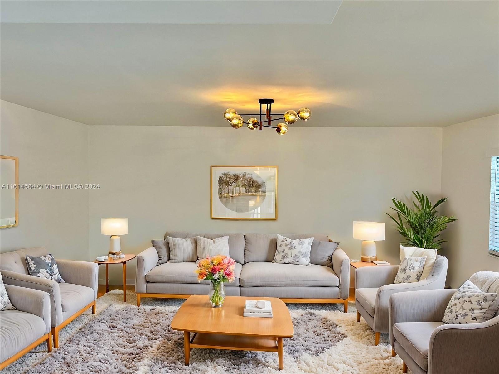 a living room with furniture and a chandelier