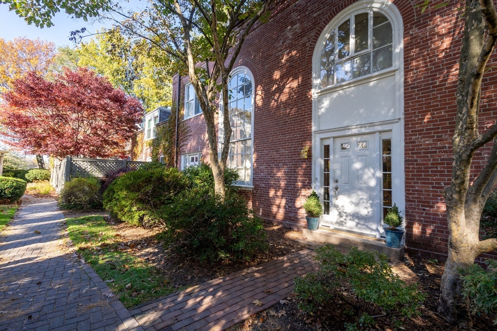 a view of a house with a yard and pathway