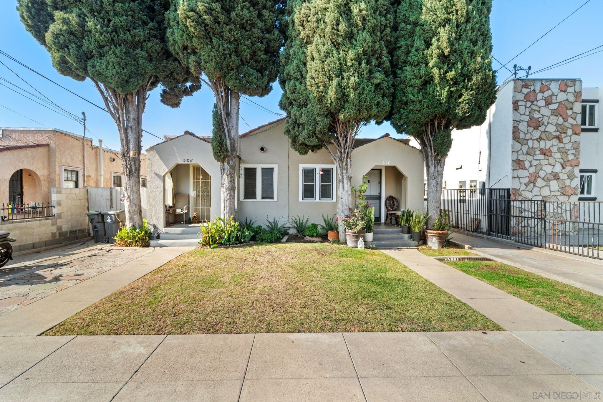 a front view of a house with yard and green space