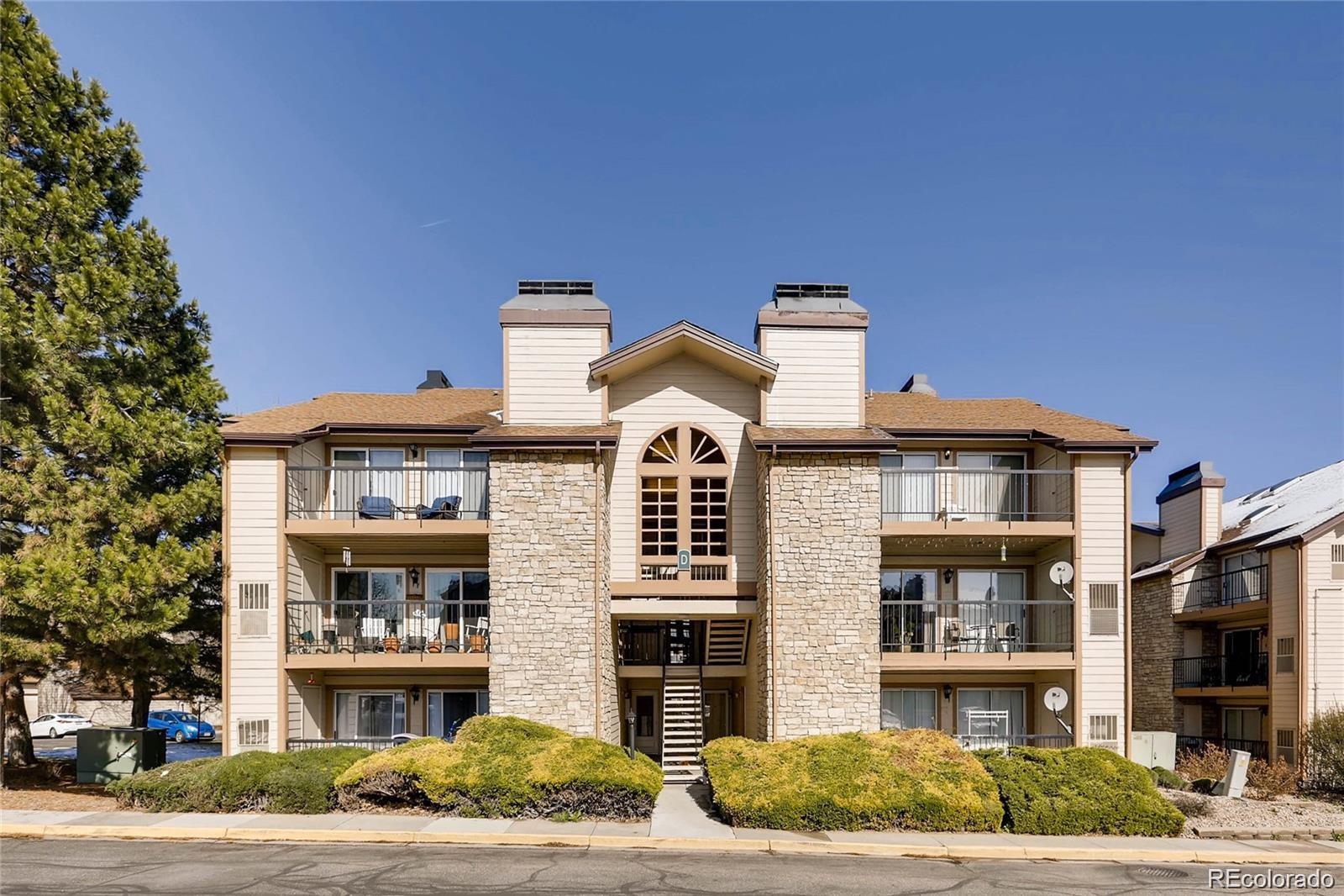 a front view of a residential apartment building with a yard