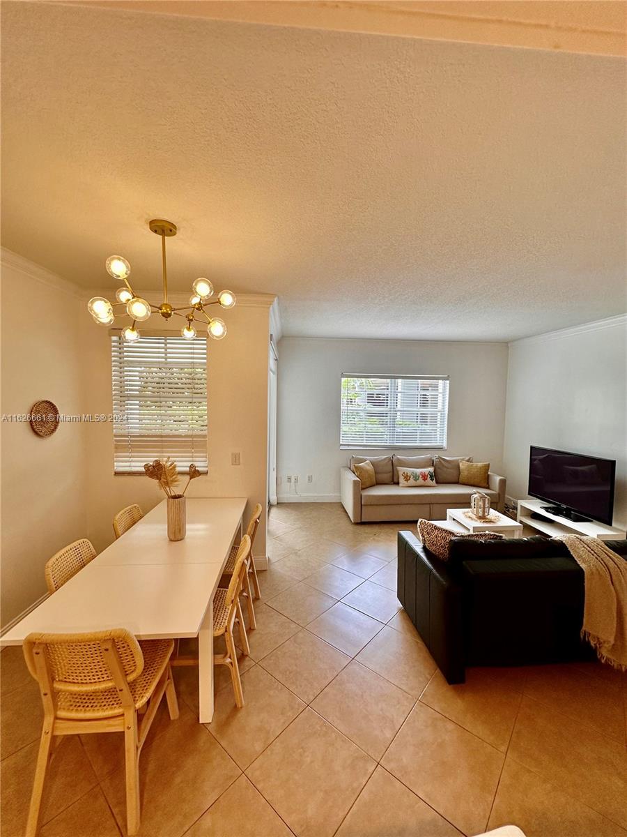 a living room with furniture a window and a table