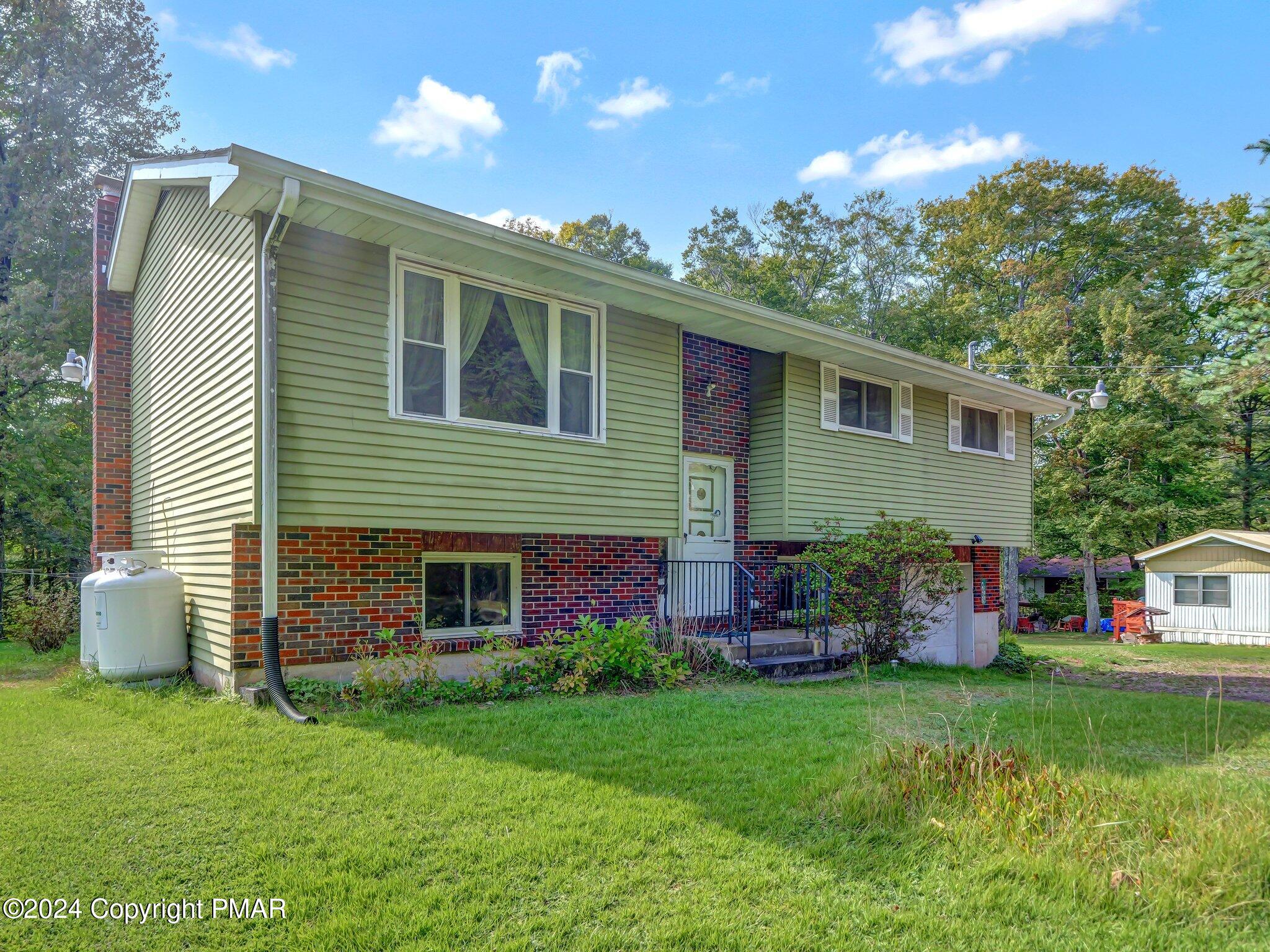 a front view of house with yard and outdoor seating