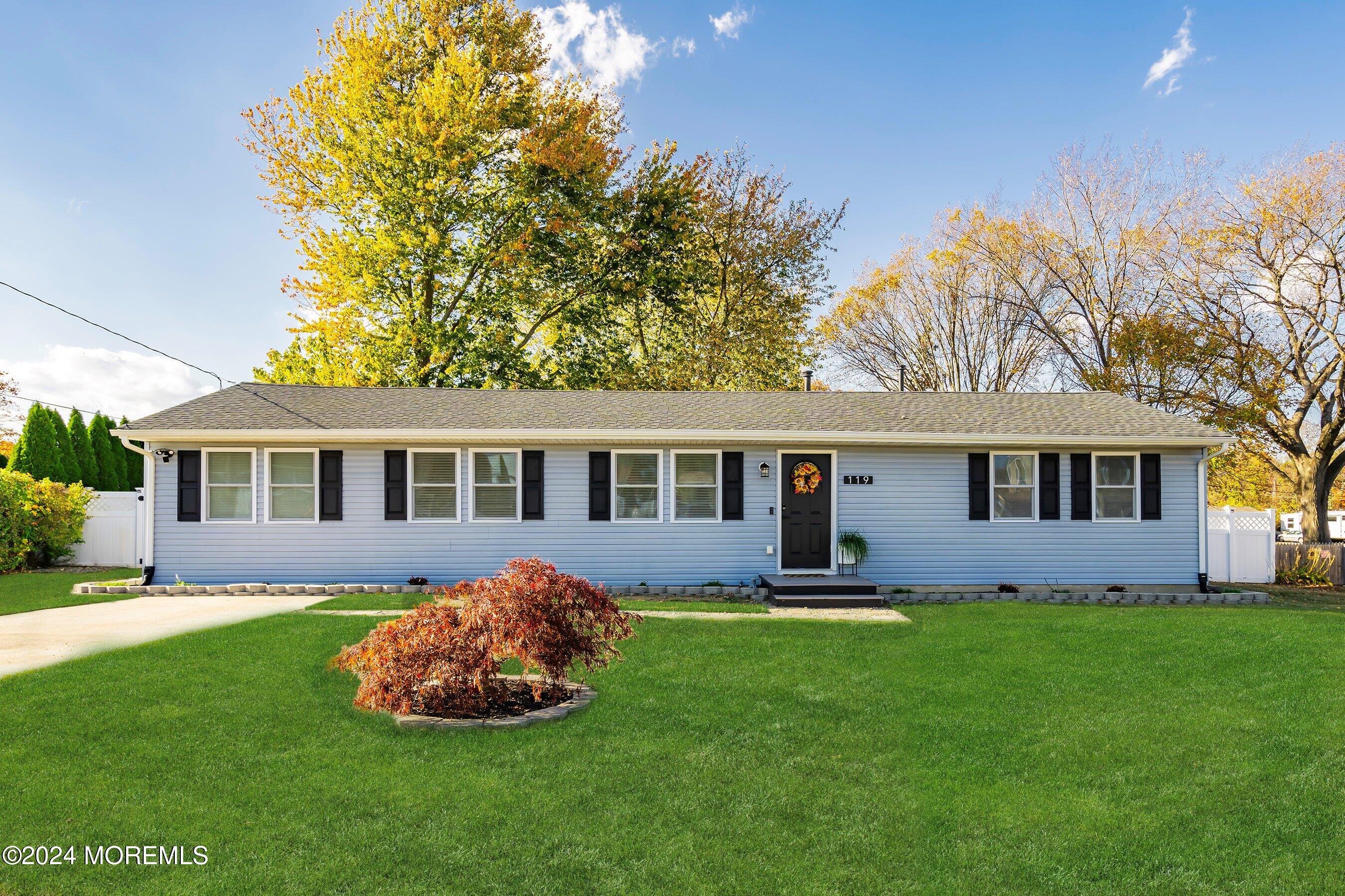 a front view of house with yard and green space