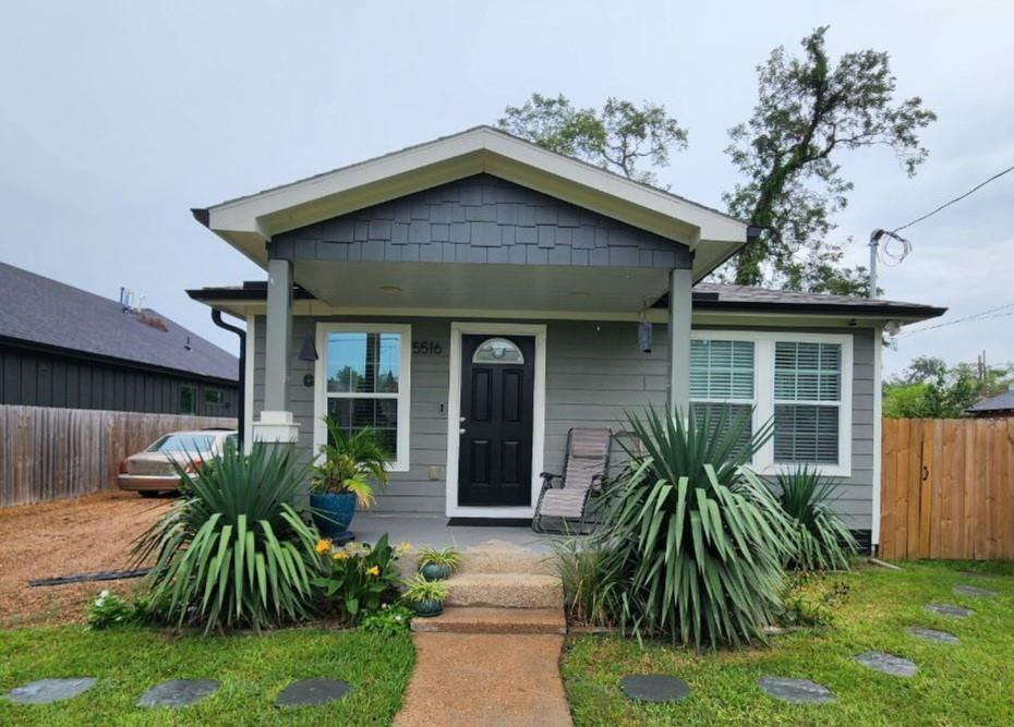 a front view of house with a garden