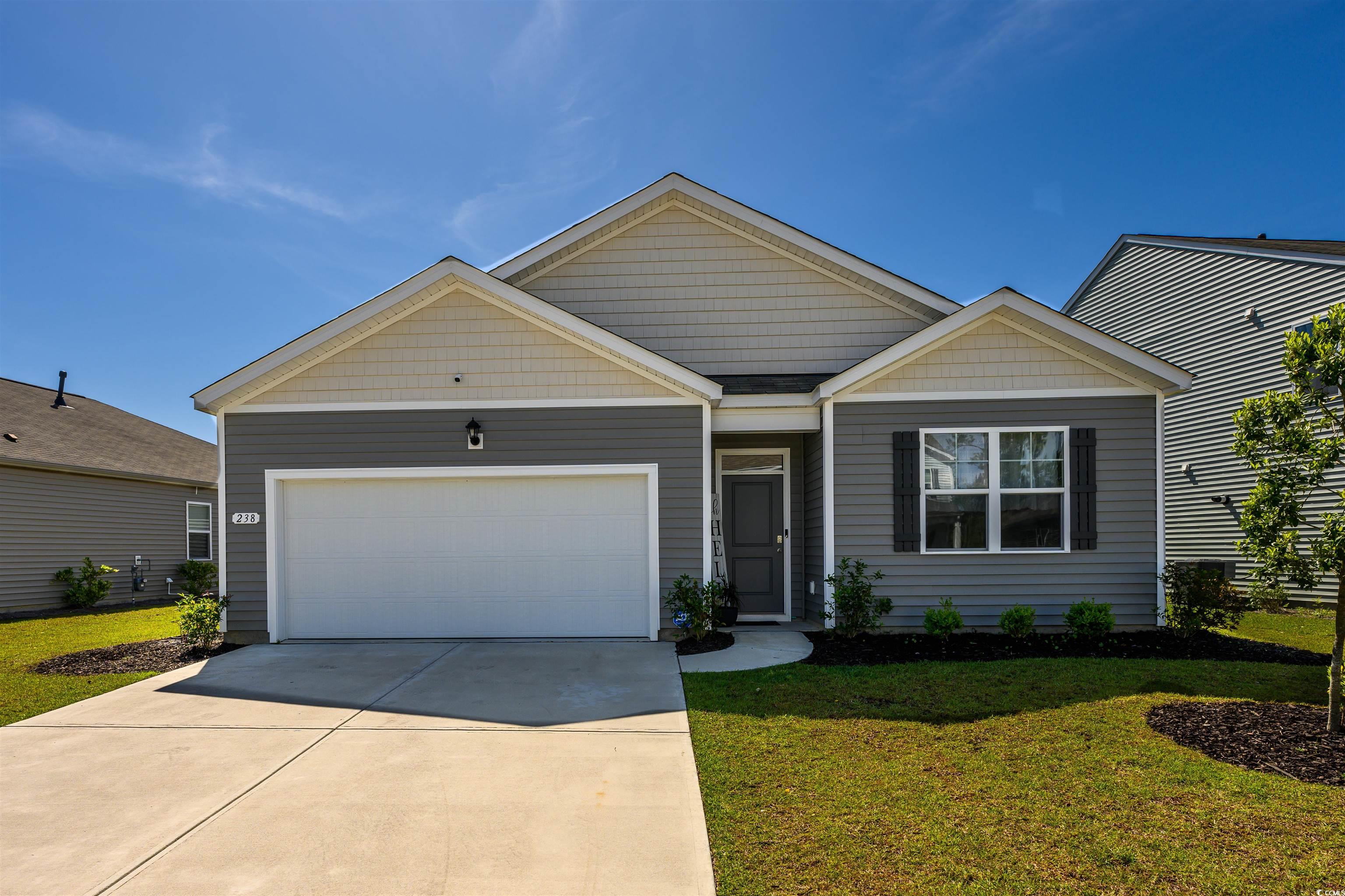 View of front of property with a garage and a fron