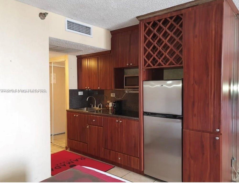 a kitchen with a refrigerator and cabinets