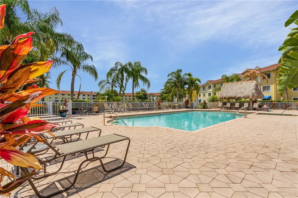 a view of swimming pool with outdoor seating and plants