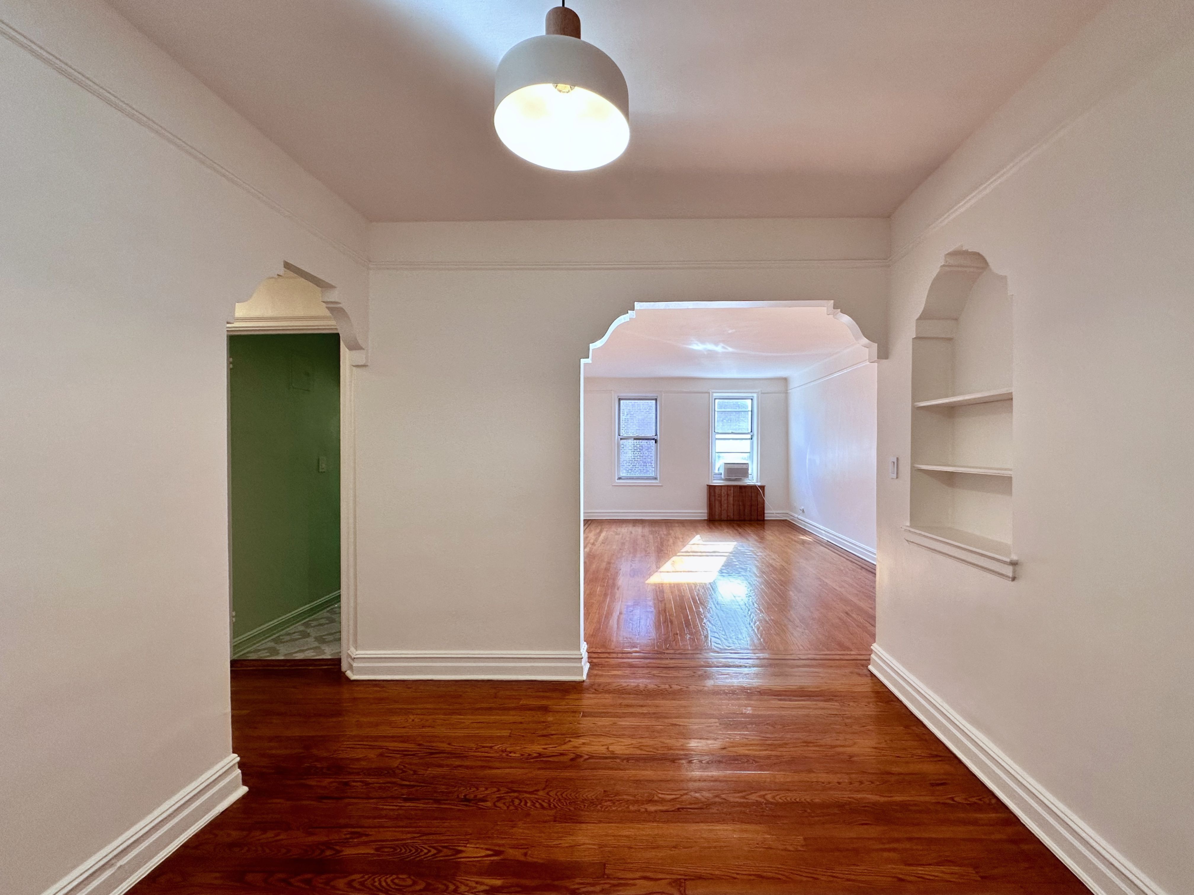 wooden floor in an empty room with a window