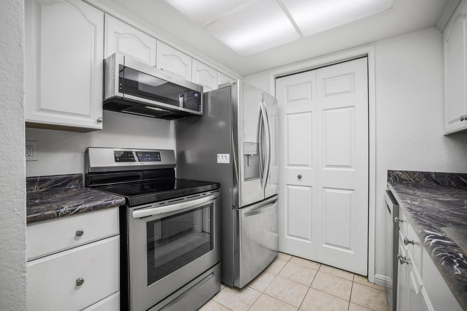 a kitchen with stainless steel appliances granite countertop a stove and a refrigerator