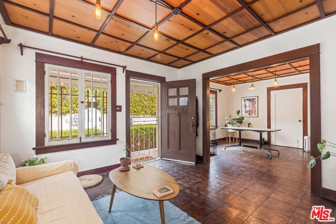 a living room with furniture a window and a chandelier