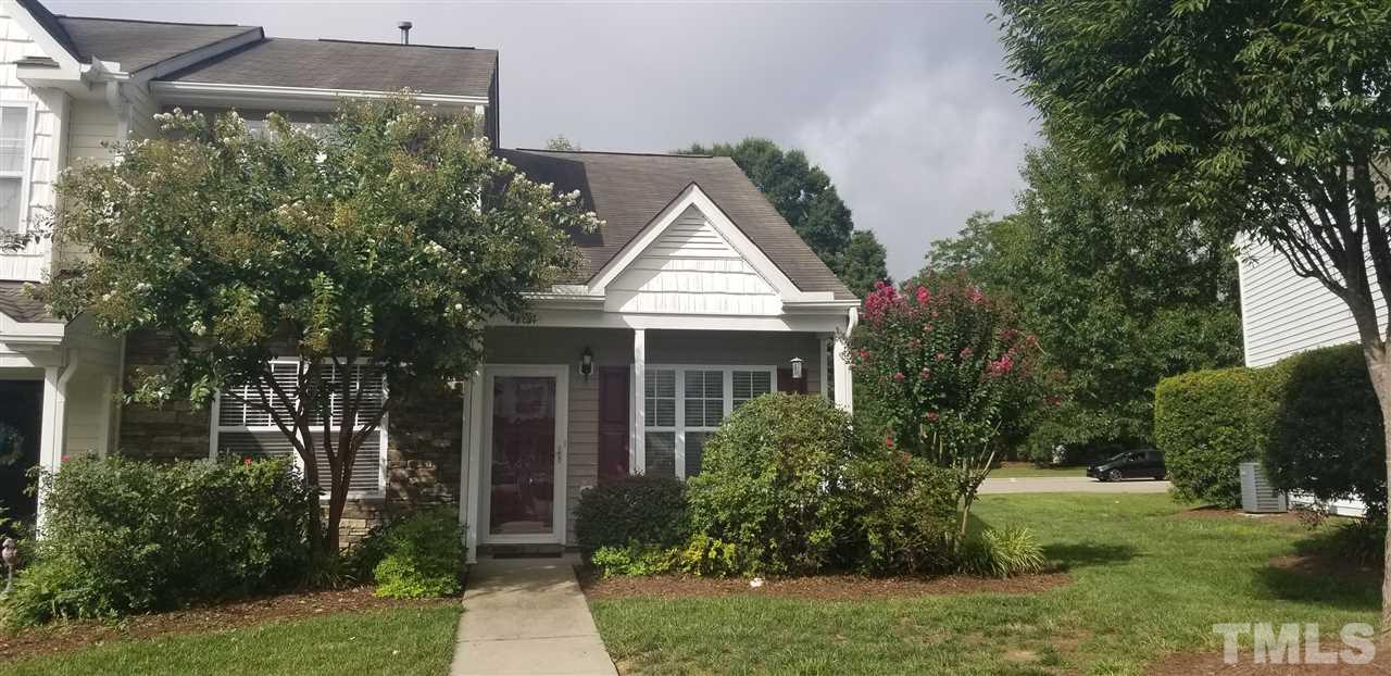 a front view of house with a garden