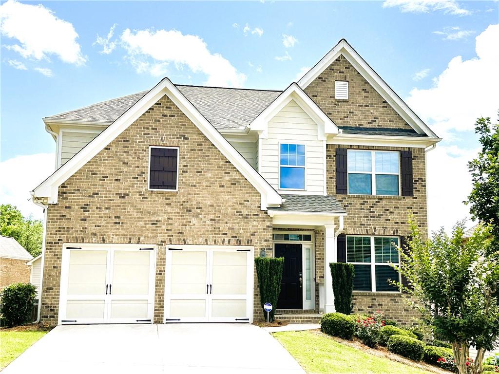 a front view of a house with garage