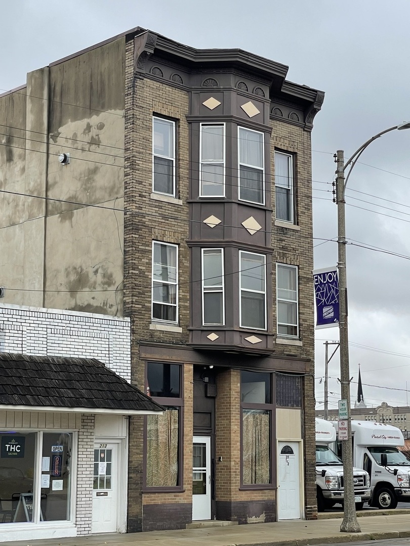 a front view of a building with a street