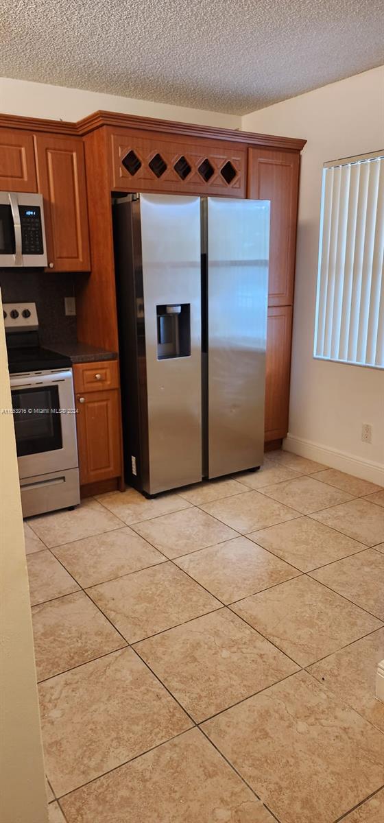 a kitchen with a stove and a refrigerator