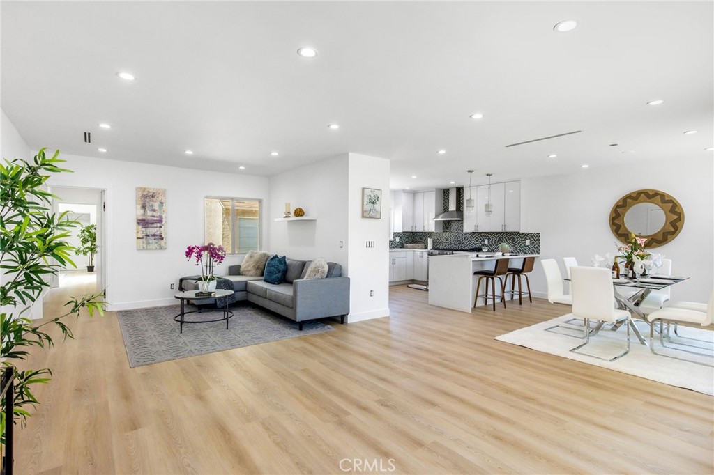 a living room with furniture and view of kitchen