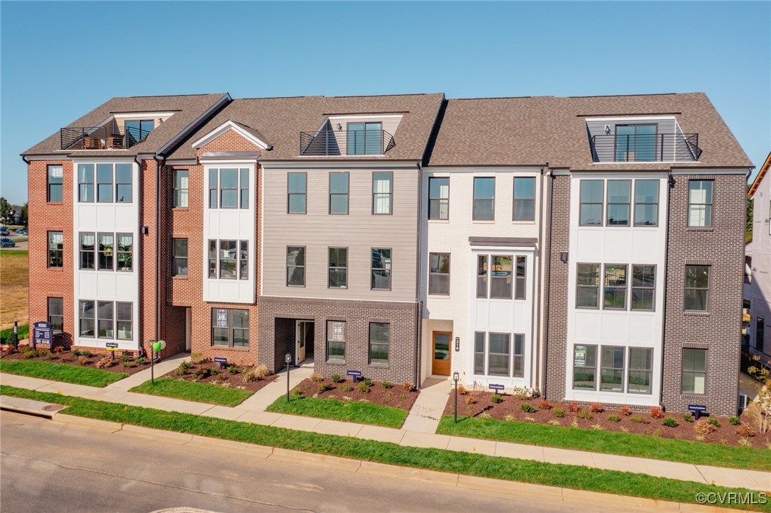 a front view of a residential apartment building with a yard