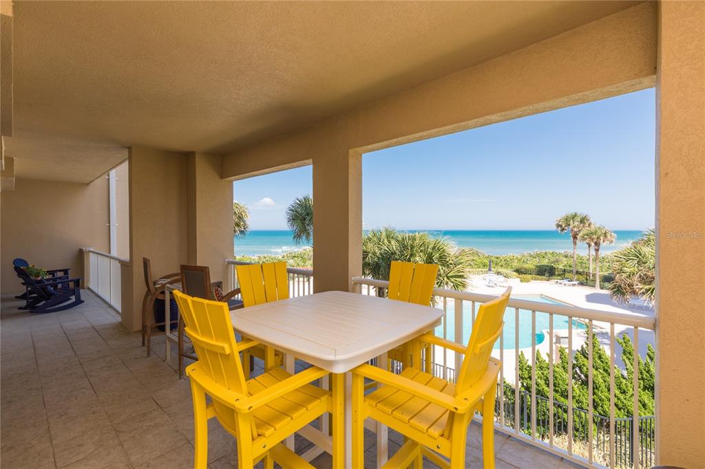 a view of a balcony with table and chairs