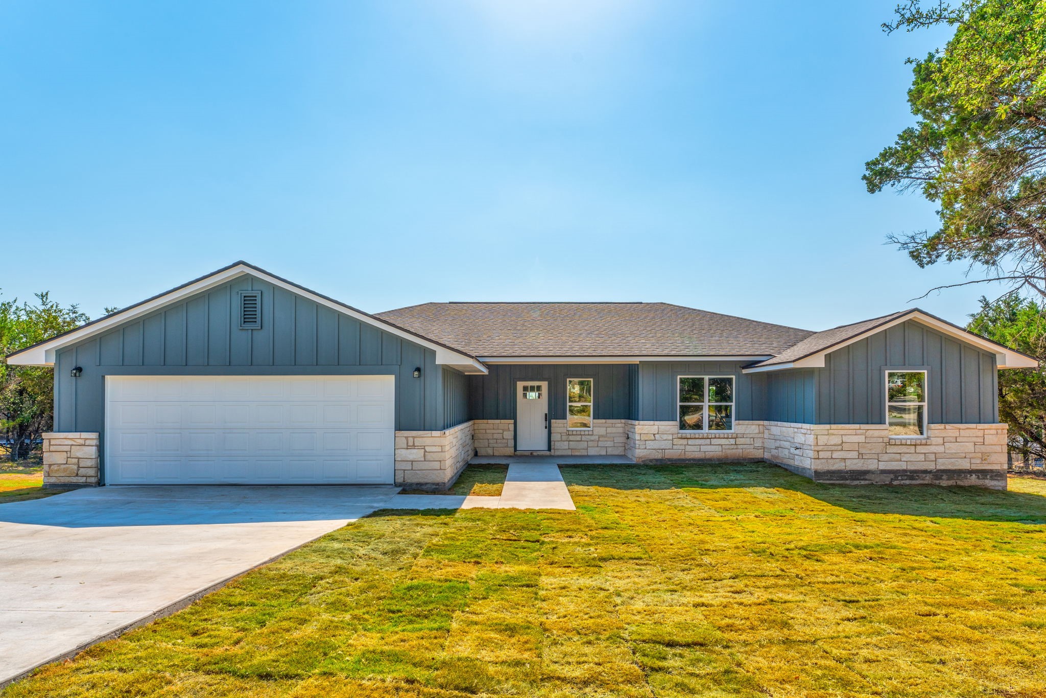 a front view of house with yard and swimming pool