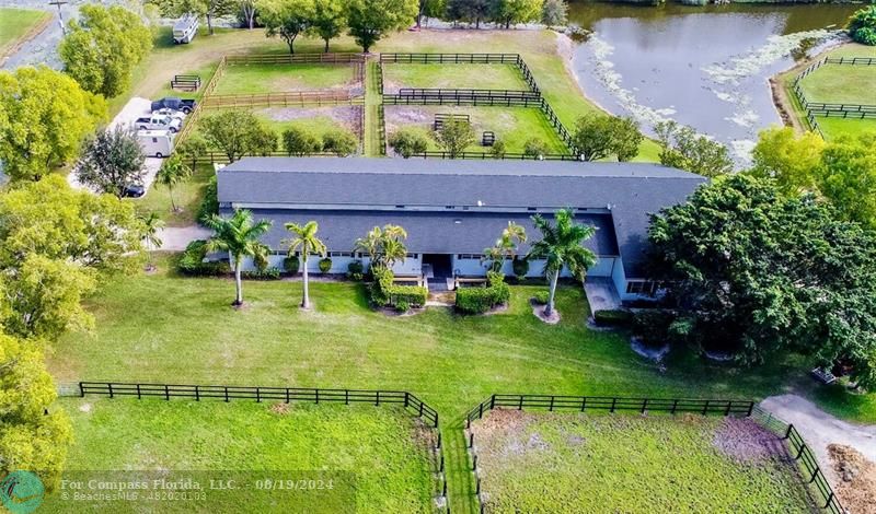 an aerial view of house with yard swimming pool and outdoor seating