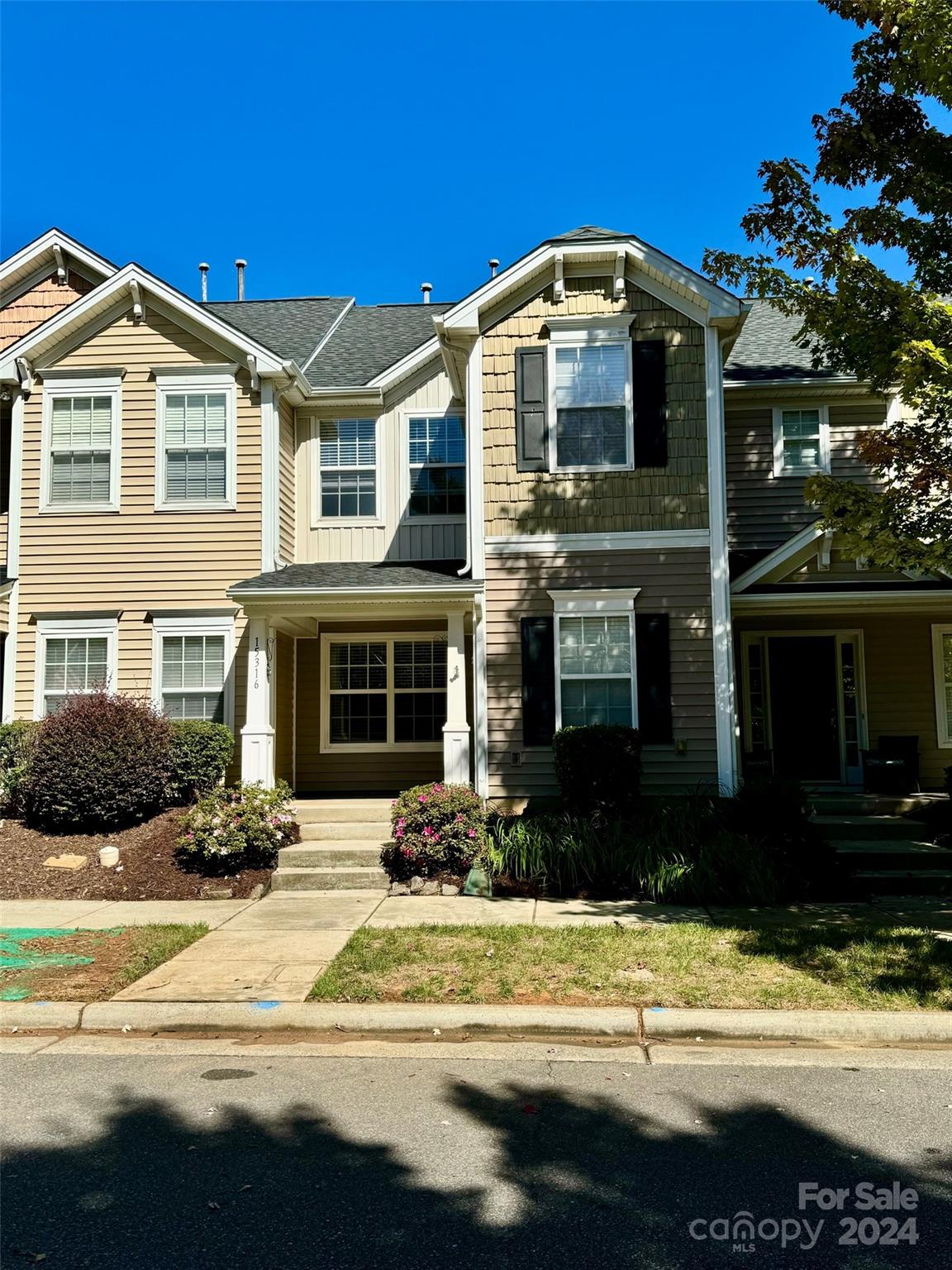 a front view of a house with a yard