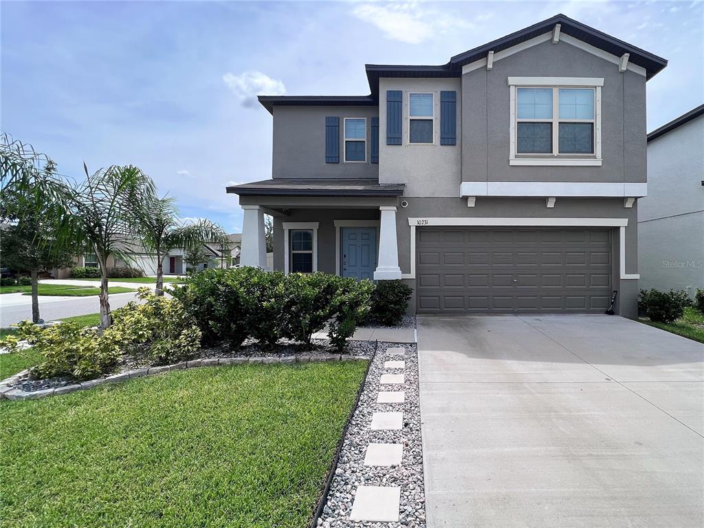 a front view of a house with a yard and garage