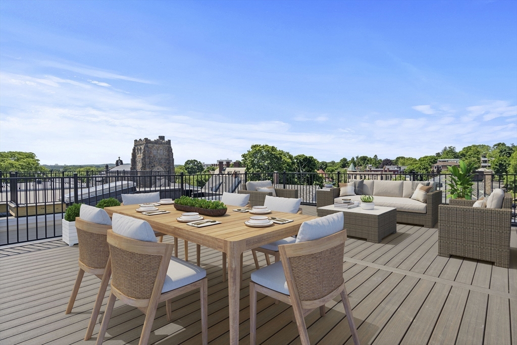 a view of a roof deck with furniture