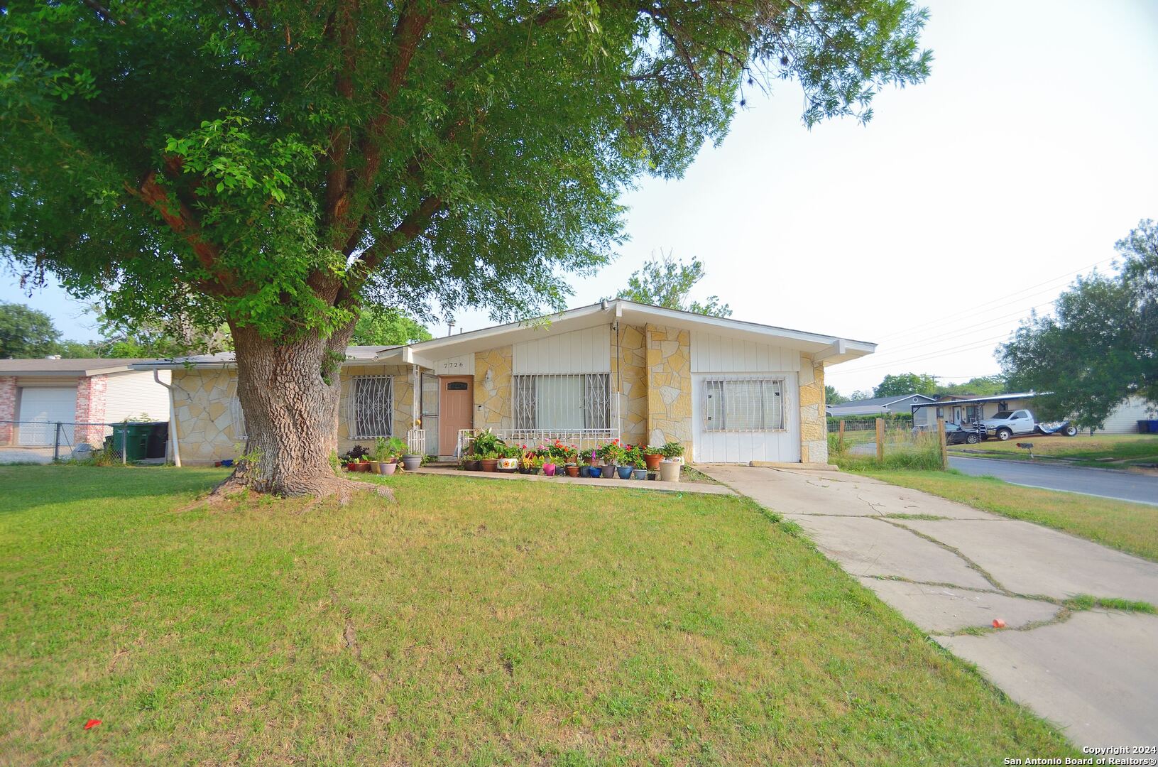 a view of a house with a yard and sitting area