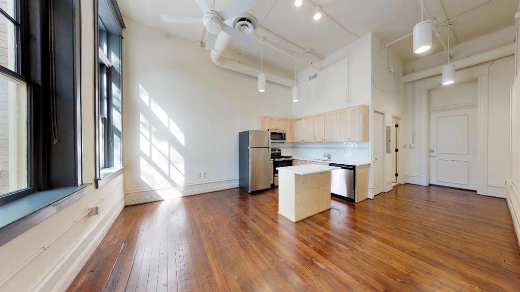 a view of kitchen with cabinets and wooden floor