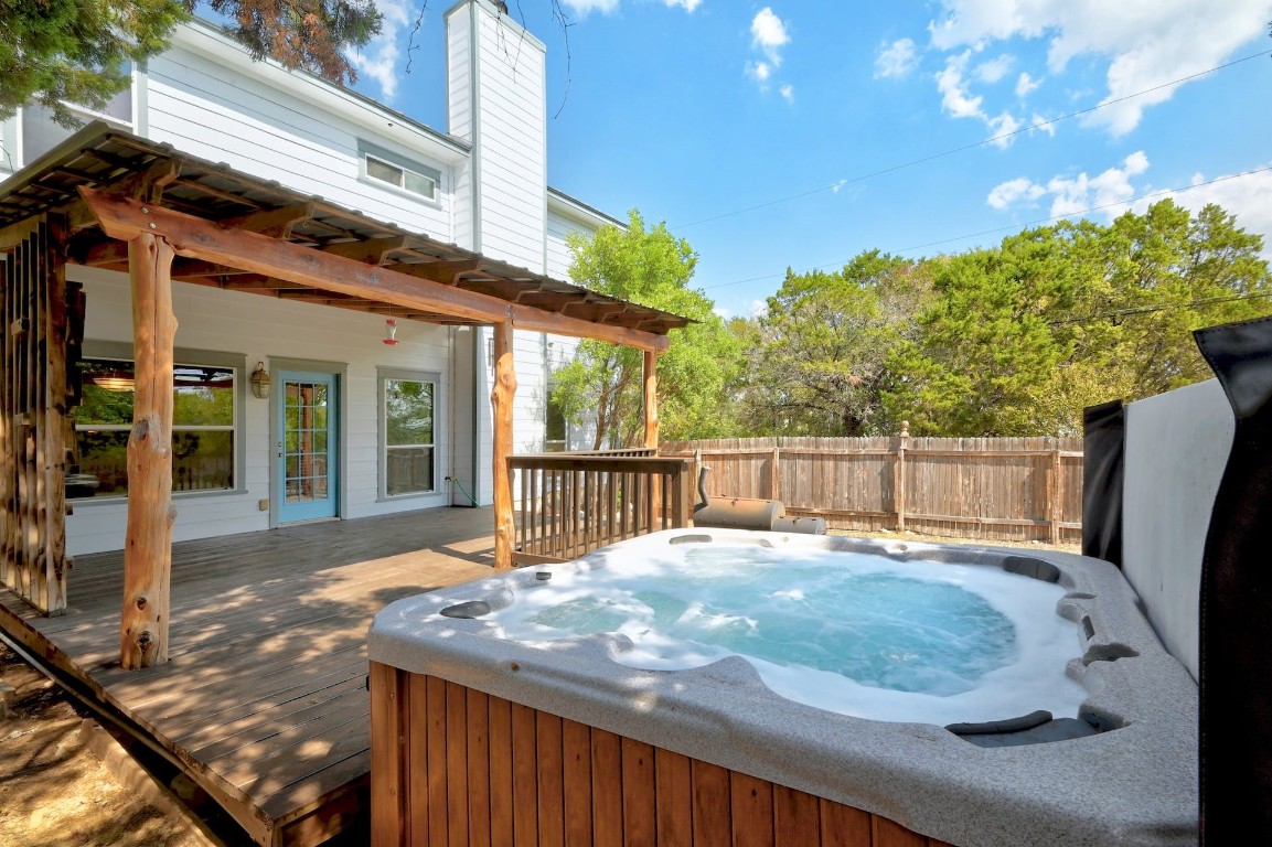 a view of backyard with deck and outdoor seating