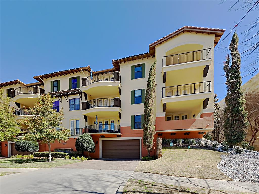 a front view of a multi story residential apartment building with yard