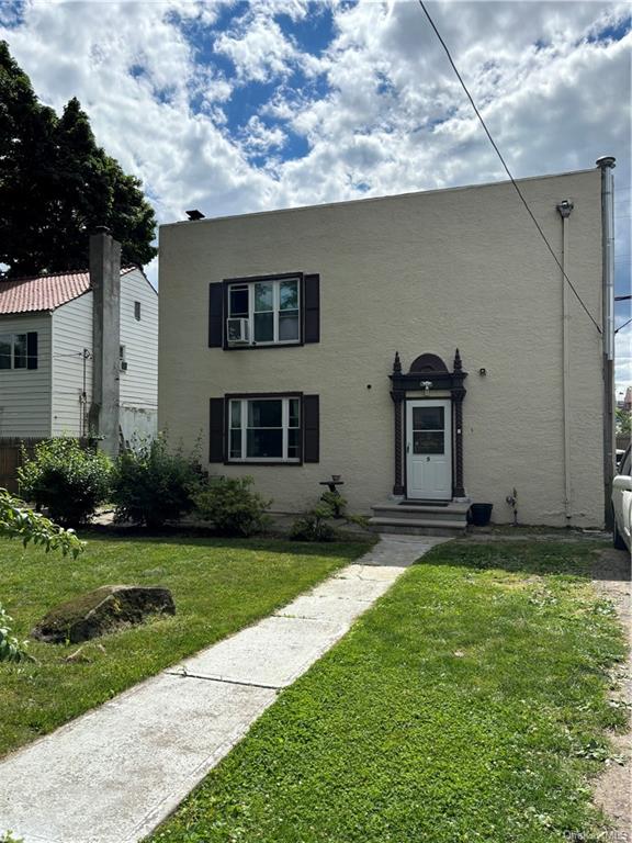 View of front of property with a front yard