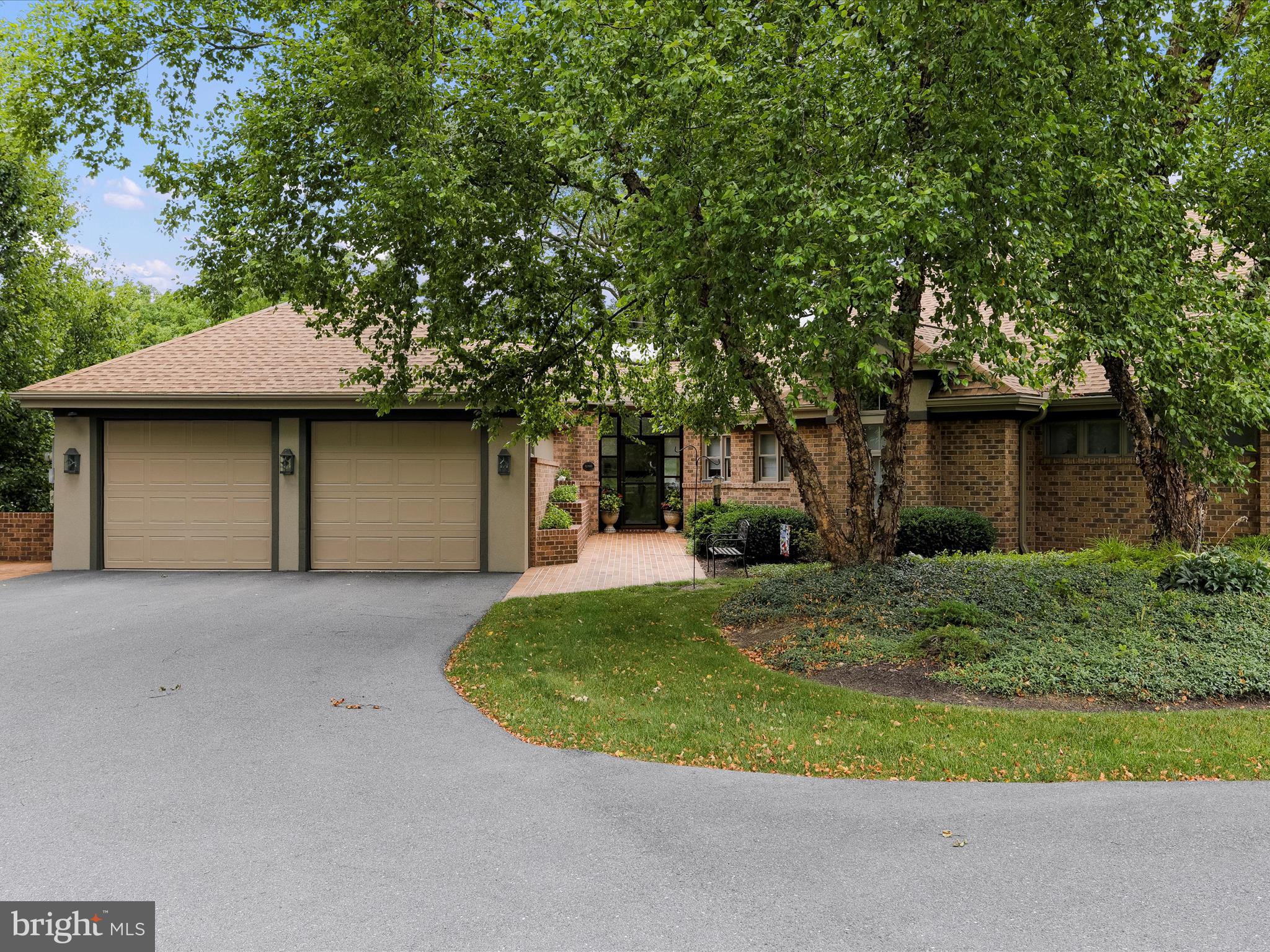 a front view of a house with a yard garage and outdoor seating