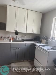 a kitchen with a sink cabinets and utility