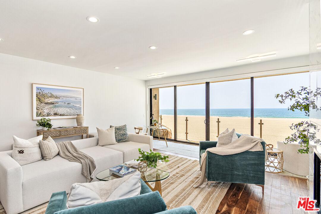 a living room with furniture and floor to ceiling windows