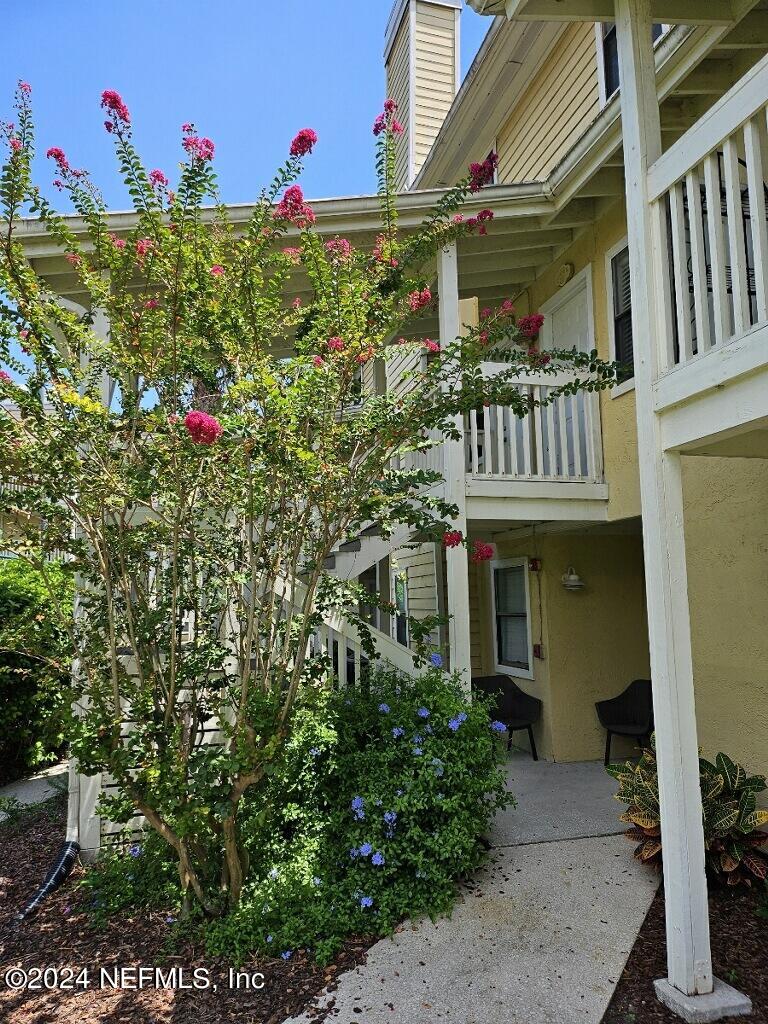 a front view of a house with a flower garden