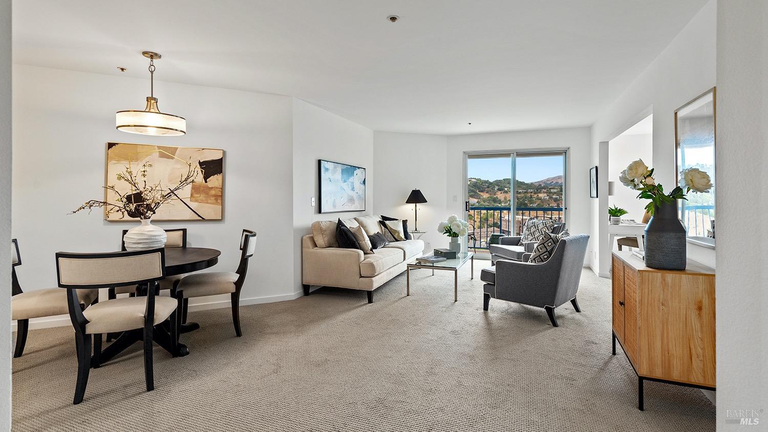 a living room with furniture and a chandelier