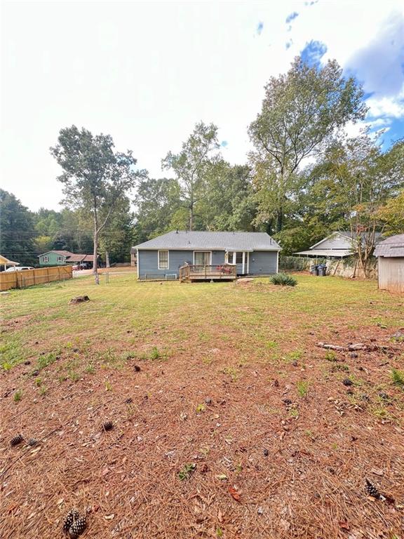 a view of a house with yard and sitting area