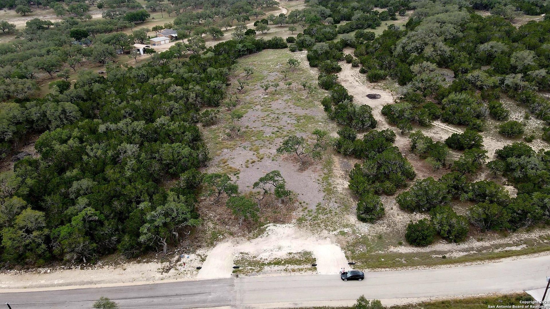 an aerial view of a house with a yard and garage