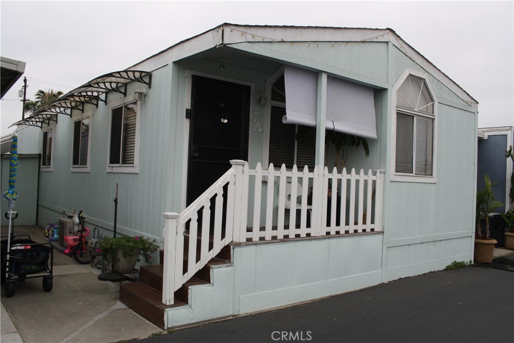 a view of a house with wooden fence