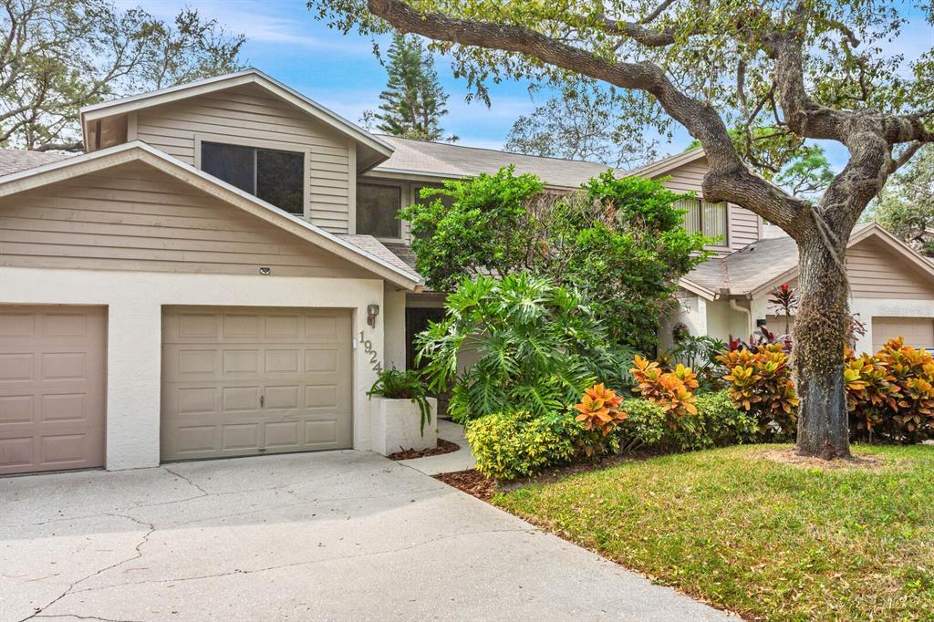 a view of a house with a yard and garage