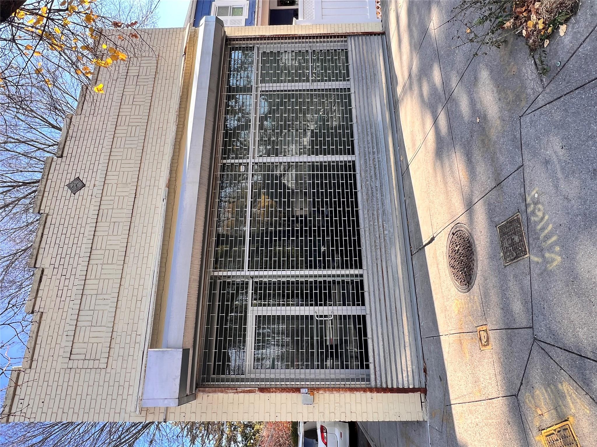 a view of a house with a large window and plants