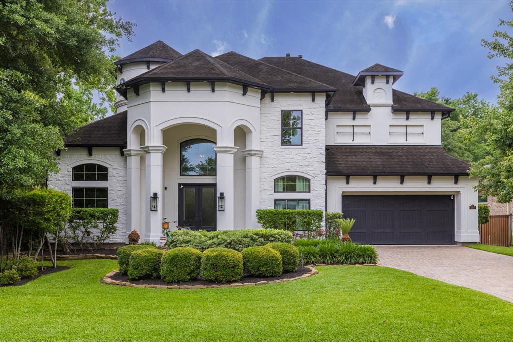 a front view of a house with a garden and plants