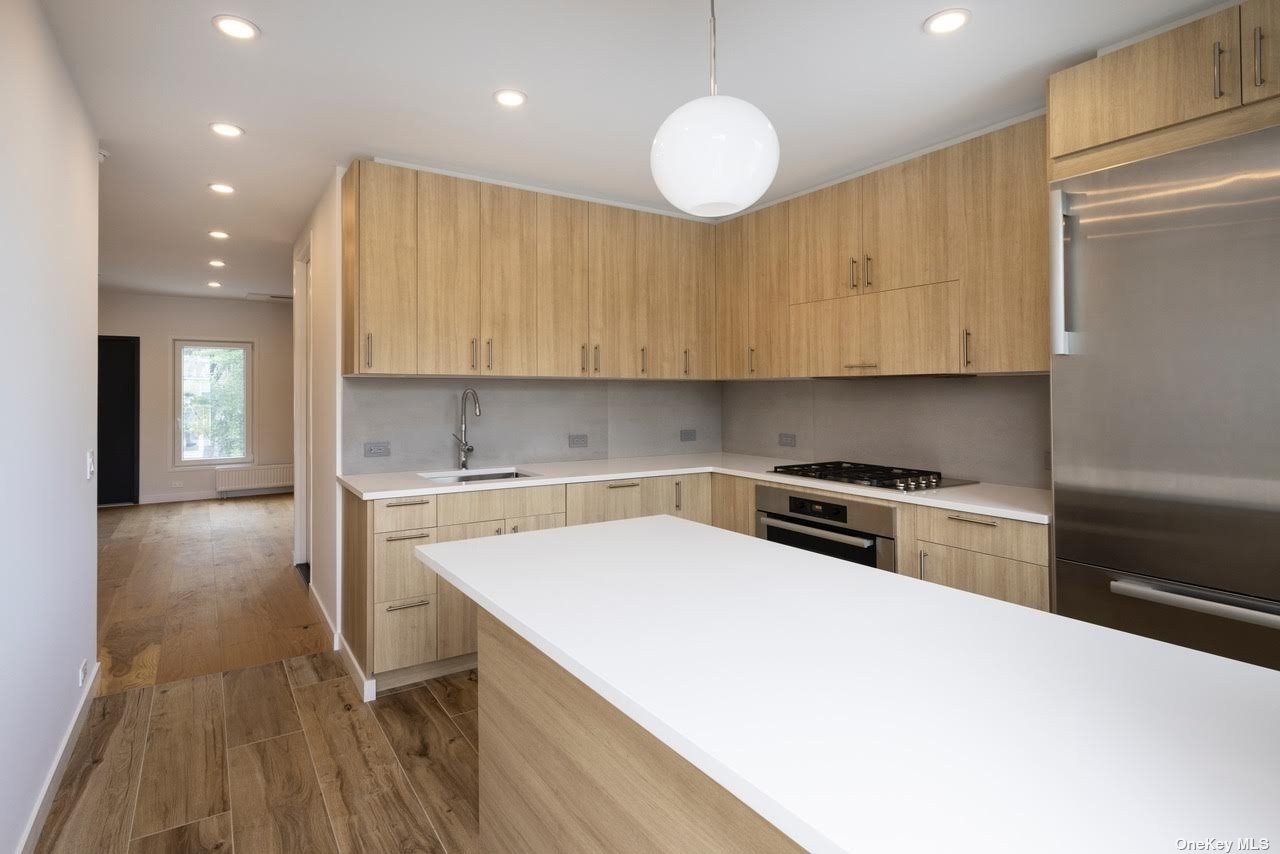 a kitchen with a sink a stove and cabinets