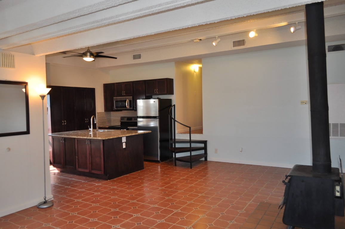 a kitchen with stainless steel appliances a refrigerator and a stove