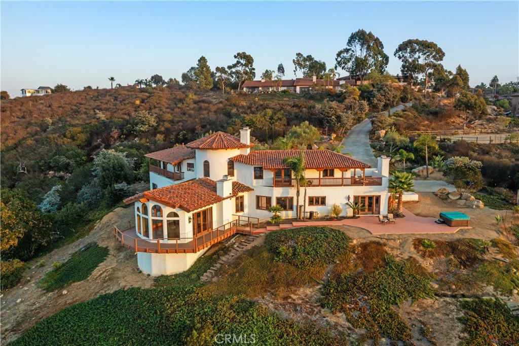 an aerial view of multiple houses with a yard